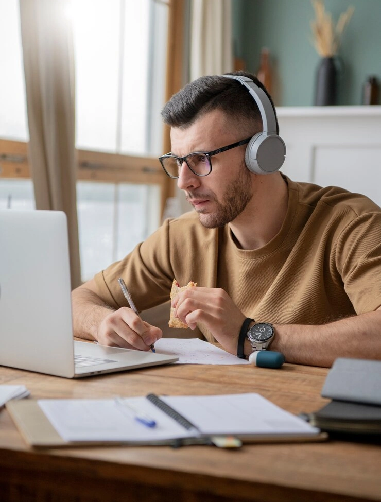 young man studying library using laptop